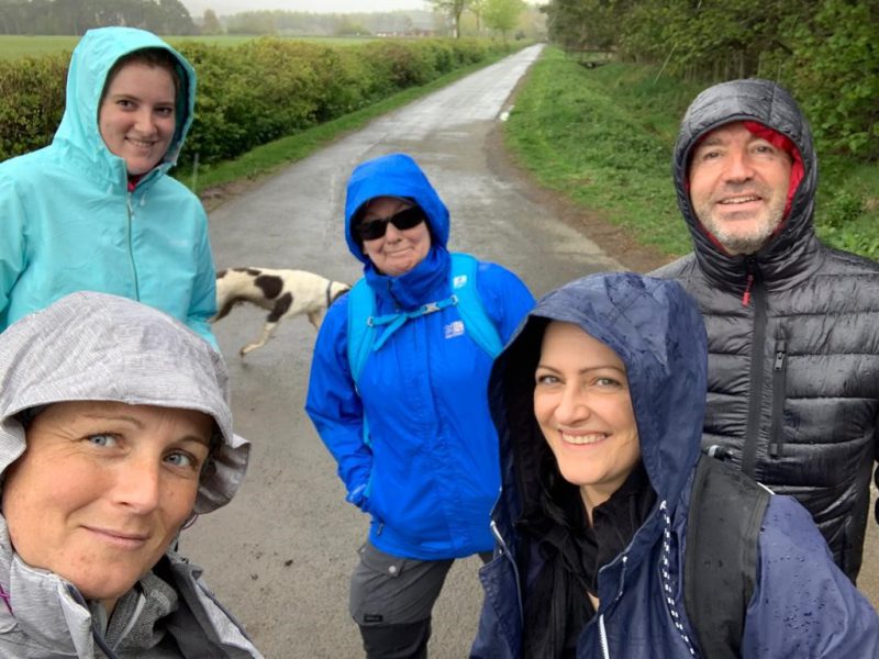 The picture shows 5 people standing on a path with their rain coats. They were training in all weathers ahead of the hike up Ben Nevis.