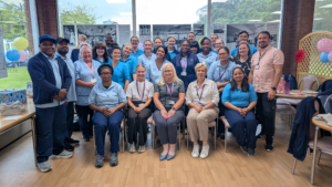 Group photo of around 25 smiling Allied Health Professionals
